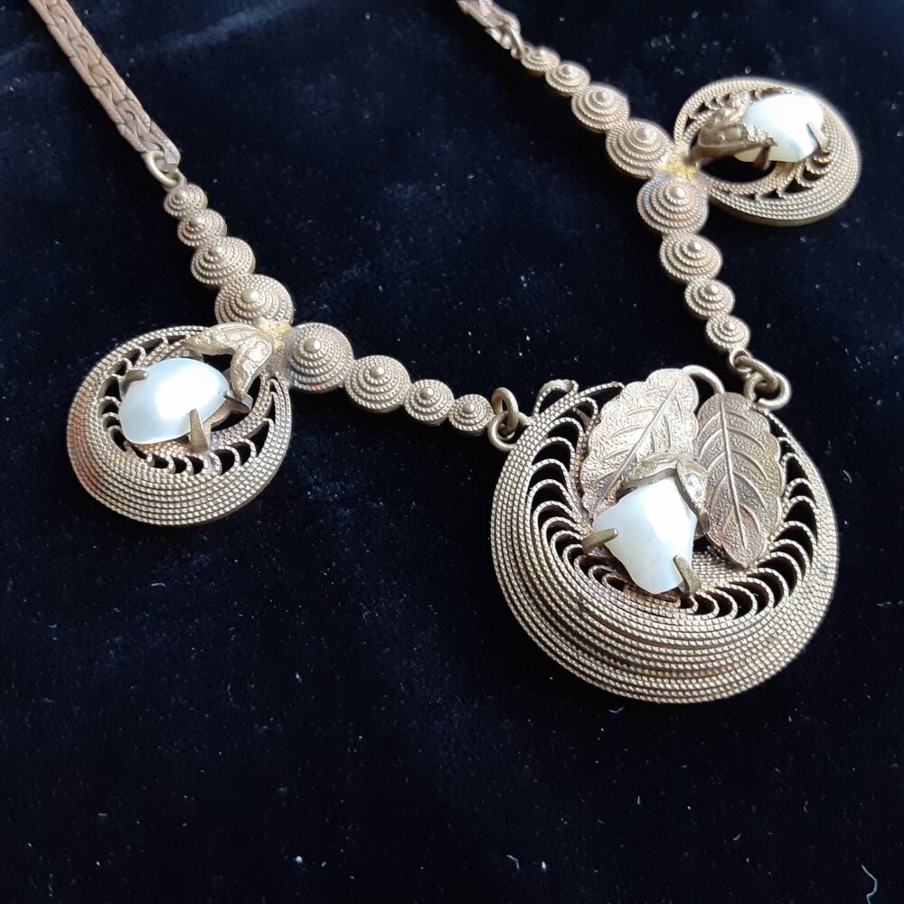 Unusual pearl and gold metal necklace